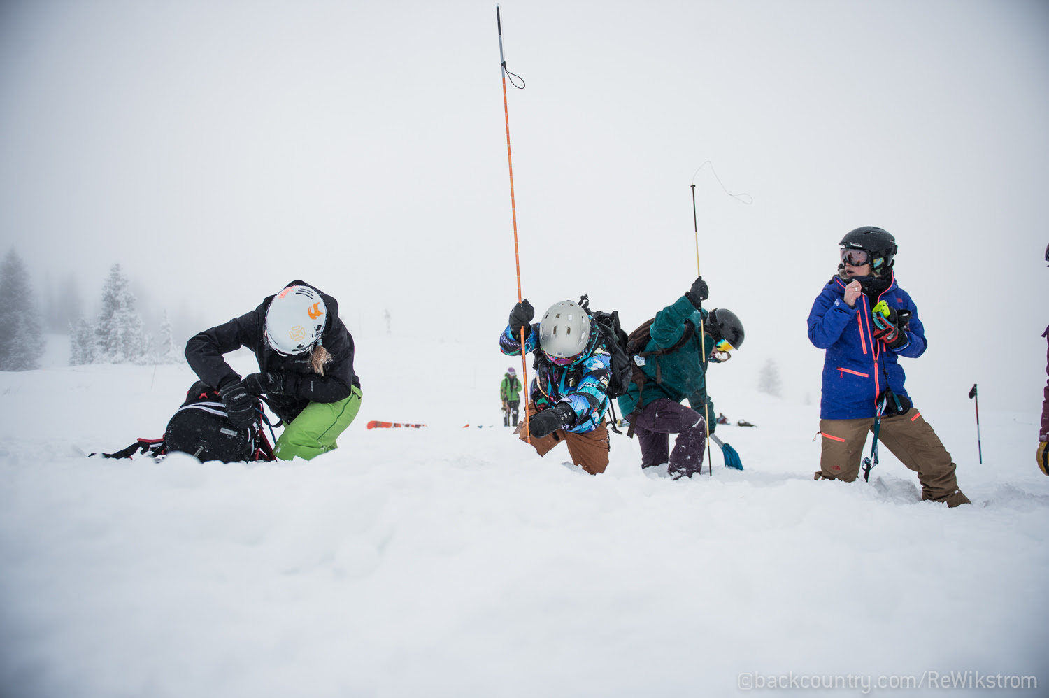 Ingrid Backstrom (right, blue jacket) leads a group of women practicing beacon searches and rescue scenarios in the afternoon field session during the SAFE-AS clinic at Snowbird, UT