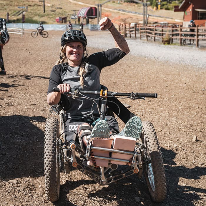 adaptive athlete stoked after riding singletrack on her adaptive mountain bike