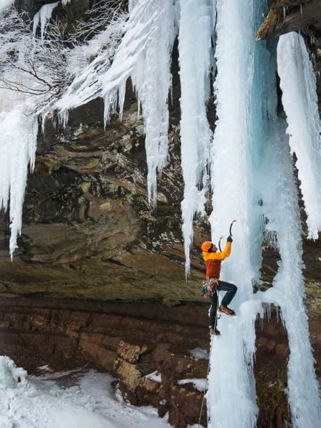Emmet Lyman climbing a frozen waterfall