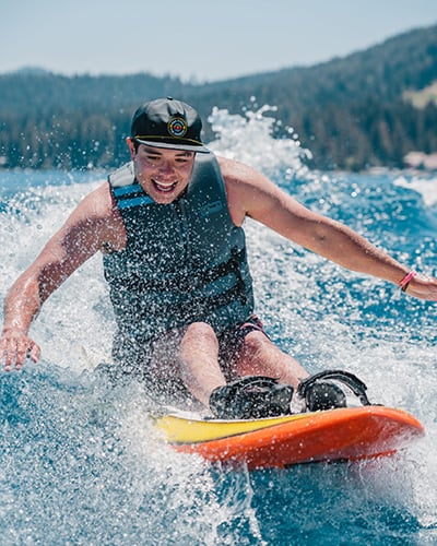 stoked adaptive wake surfer riding wave