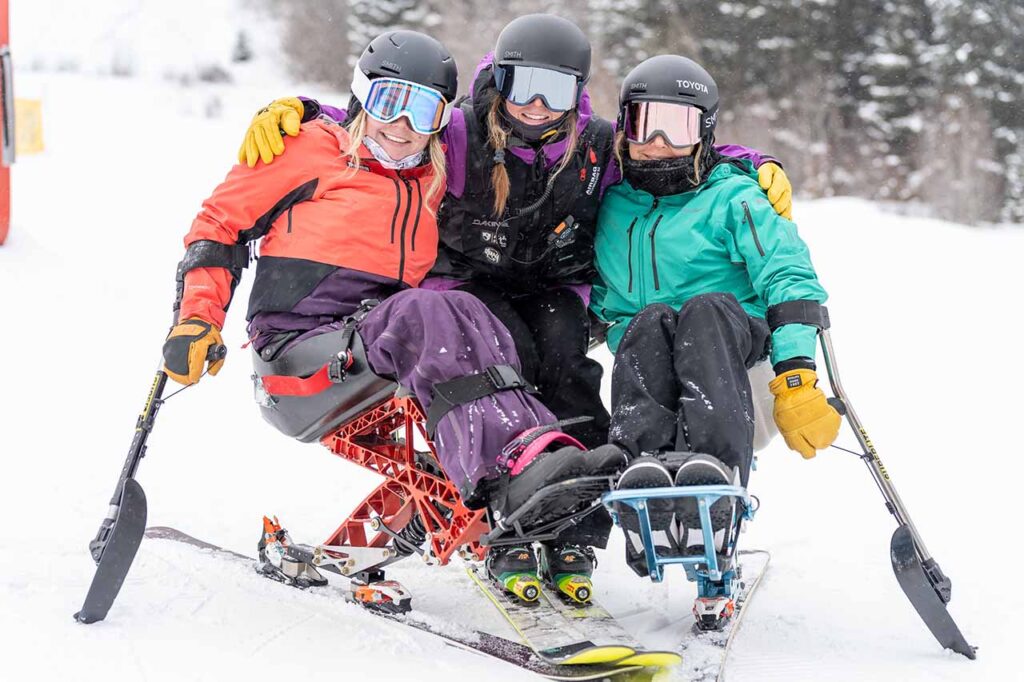 adaptive skiiers and trainer