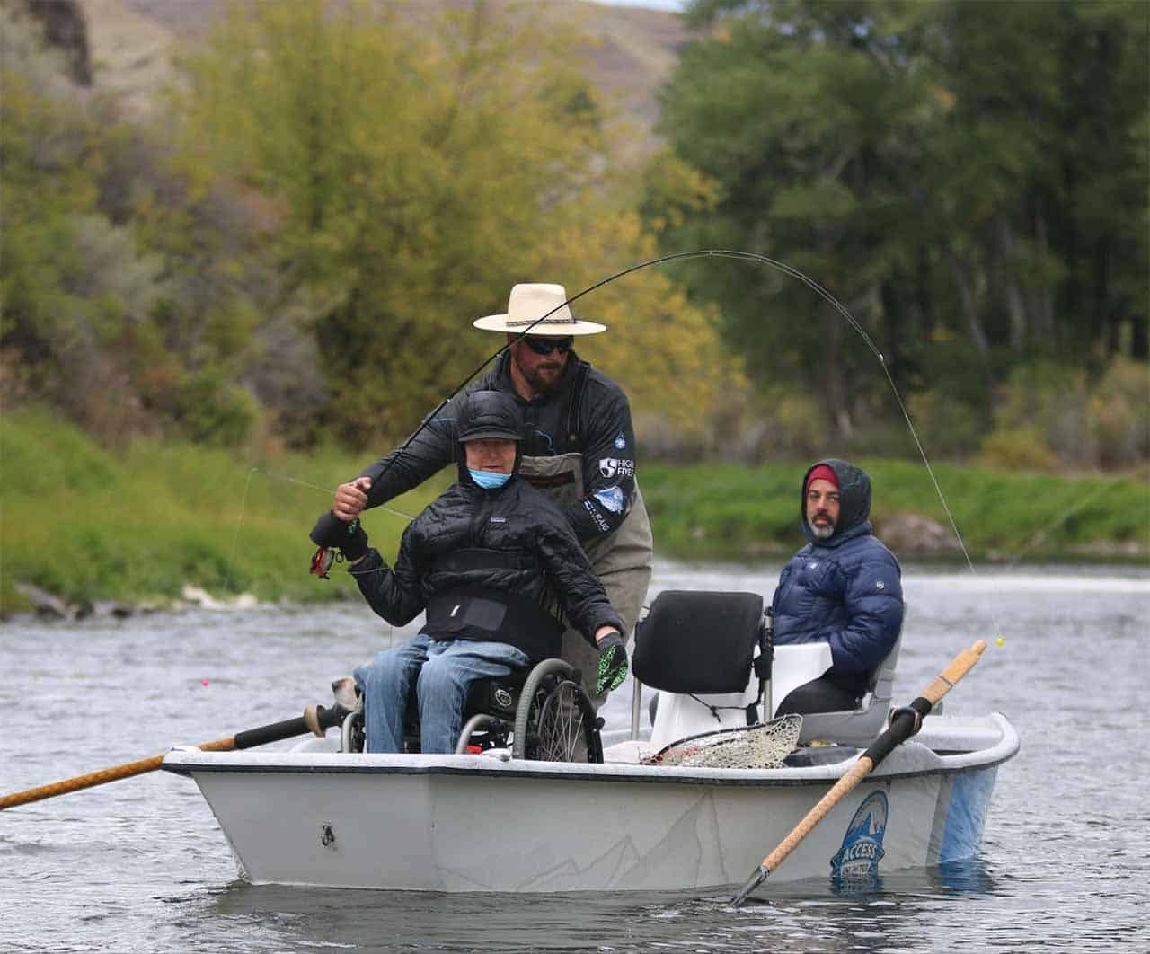 adaptive fly fisherman fishing in boat in river