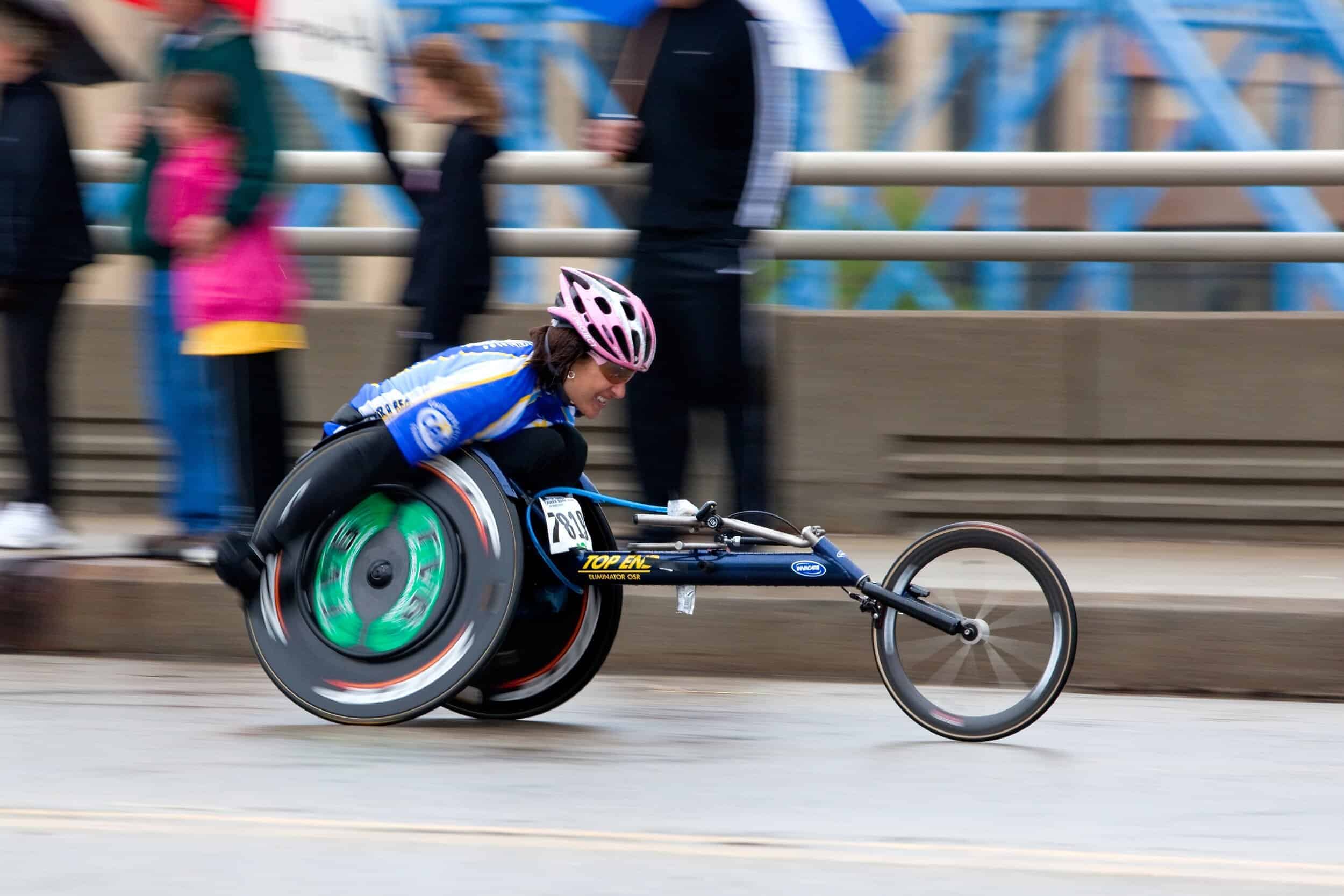 An athlete participating in an adaptive sports charity program outdoors.