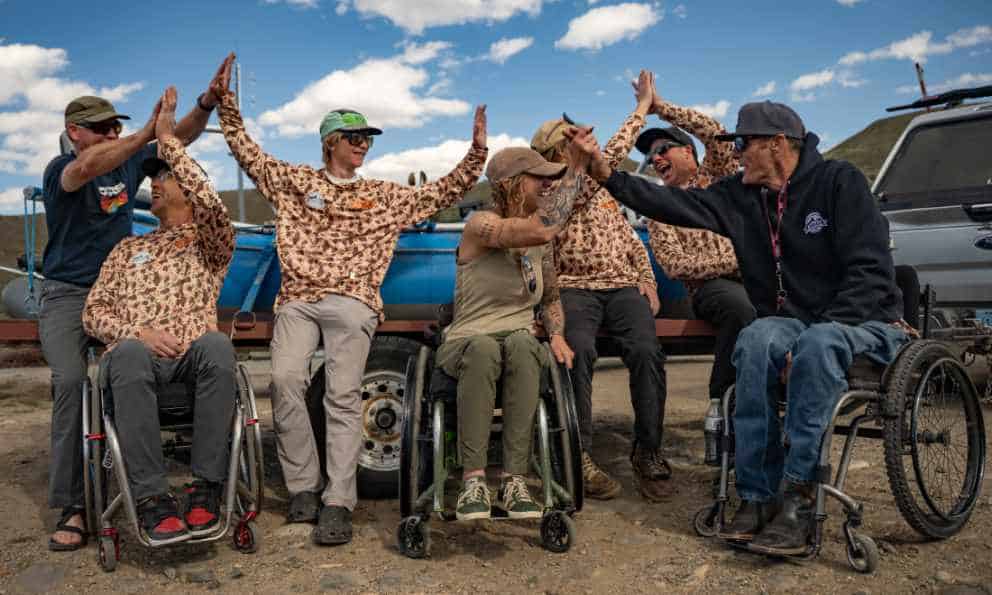 group of high fives foundation athletes and staff high five each other
